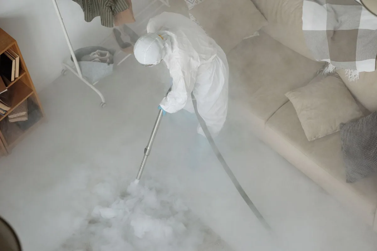 Biohazard cleanup technician in protective equipment, Lame Deer, MT